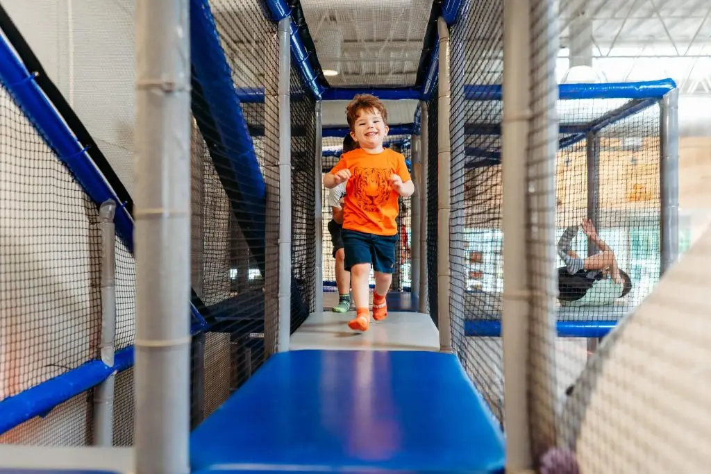 toddler boy joyfully running at ready set fun indoor playground sandy springs