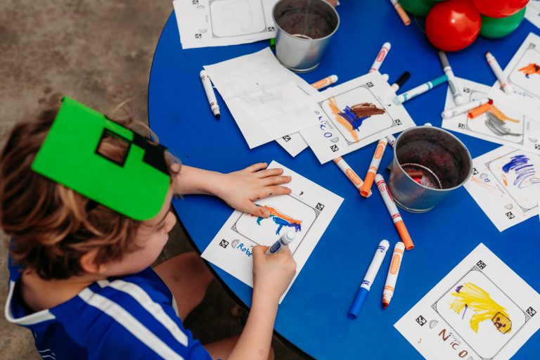 Child doing imagination art coloring activity at Ready Set Fun indoor playground in Sandy Springs