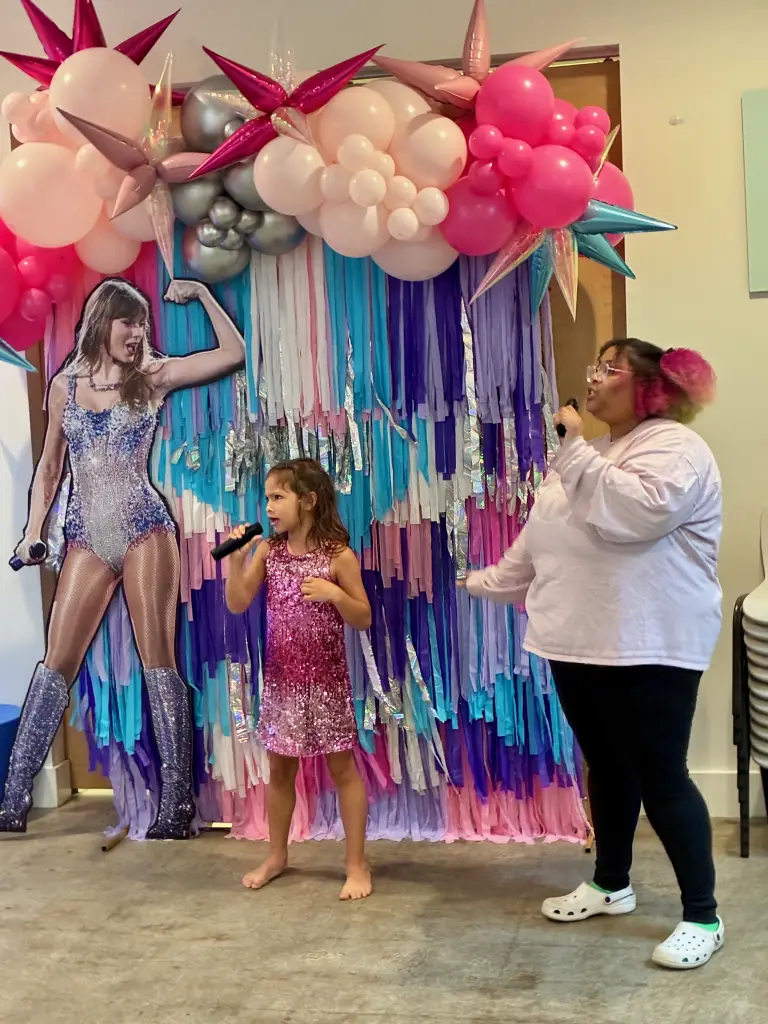 6 year old girl performing karaoke at pop star birthday party at Ready Set Fun in Sandy Springs