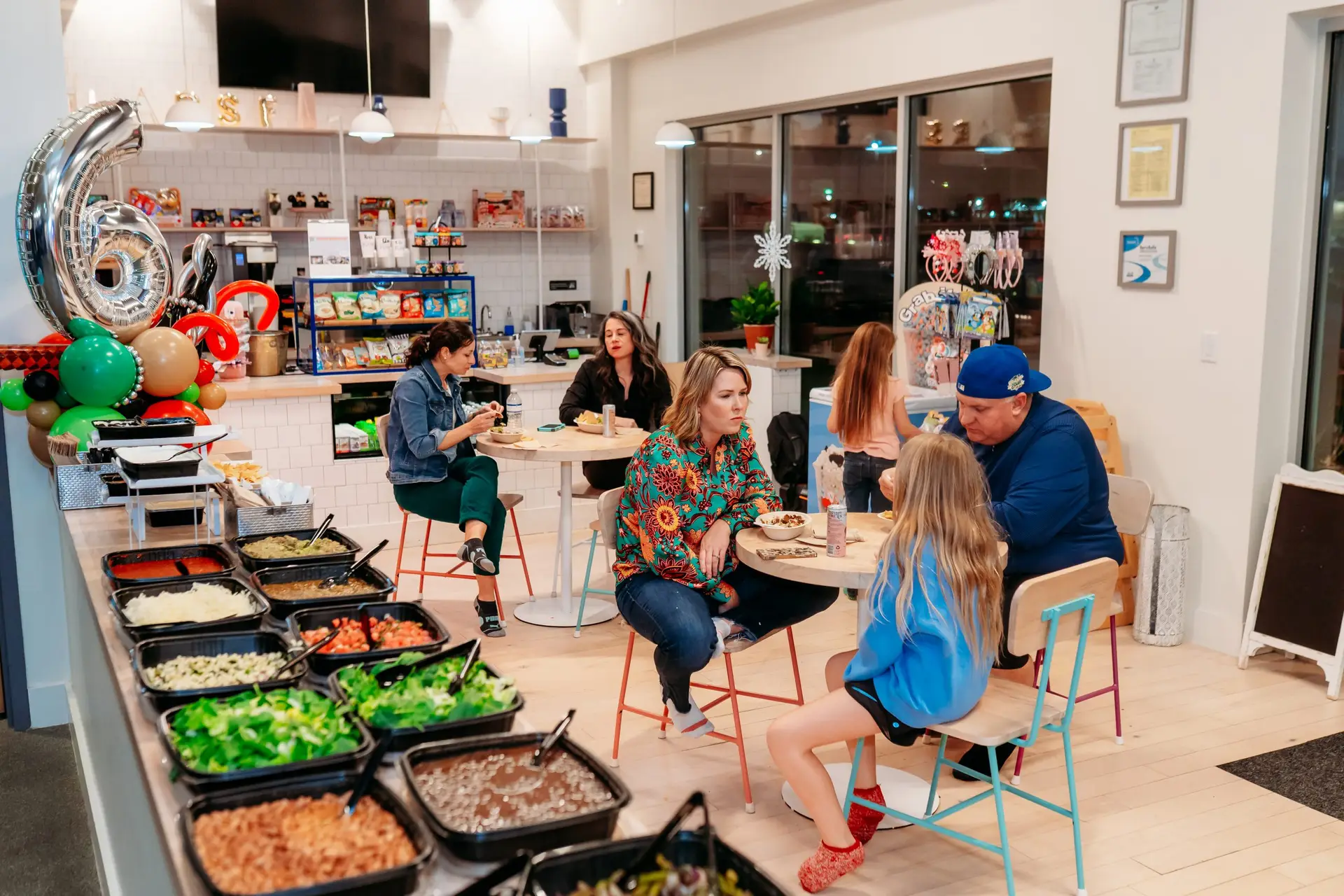 Adults enjoying catering in the cafe during a private birthday party at Ready Set Fun in Sandy Springs