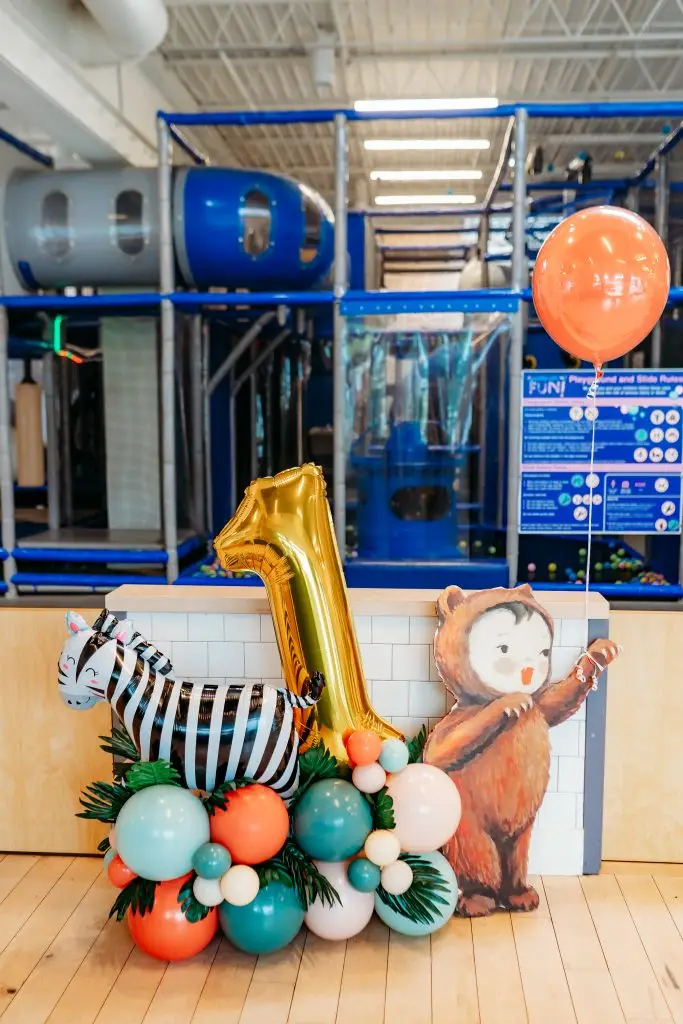 first birthday ballon decorations in front of indoor playground for private kids birthday party