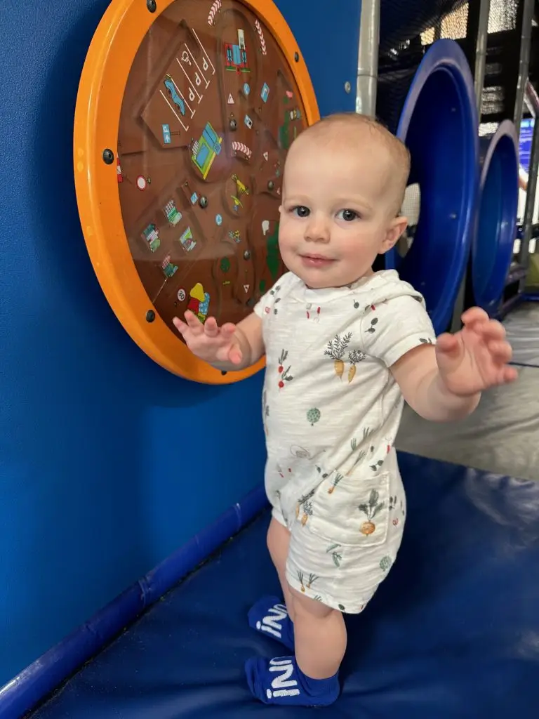 babay standing at activity panel indoor playground ready set fun sandy springs