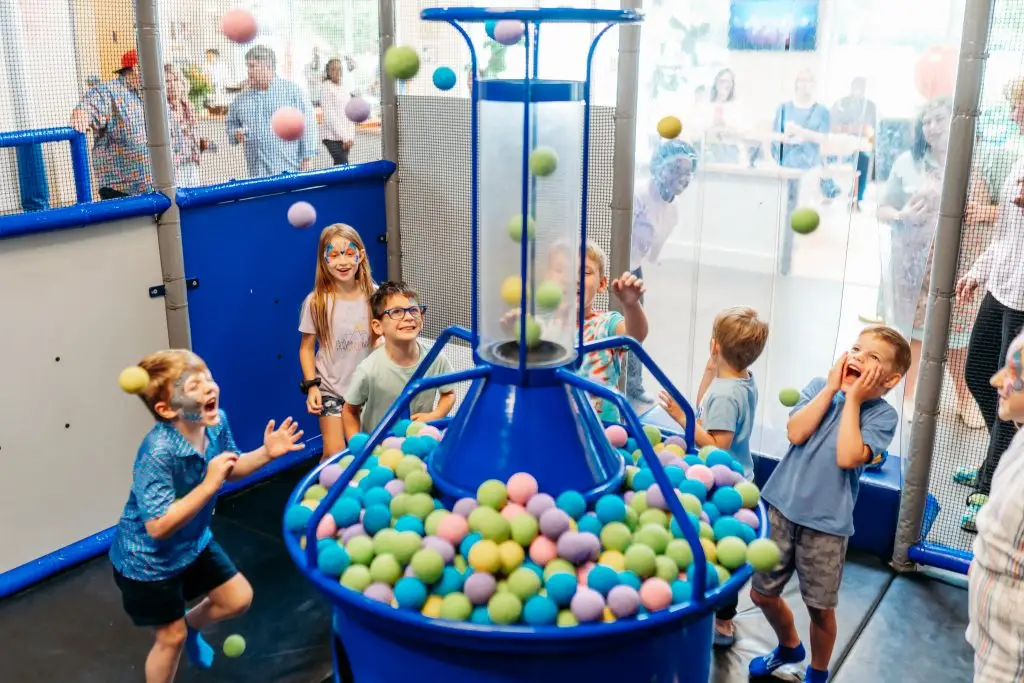 Kids playing at the ball fountain on the two-story indoor playground at Ready Set Fun in Sandy Springs