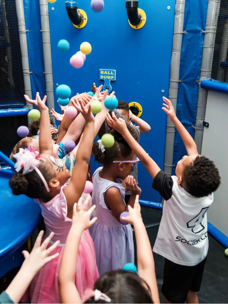 Kids laughing and playing together in the ball pit at Ready Set FUN indoor playground in Sandy Springs, GA