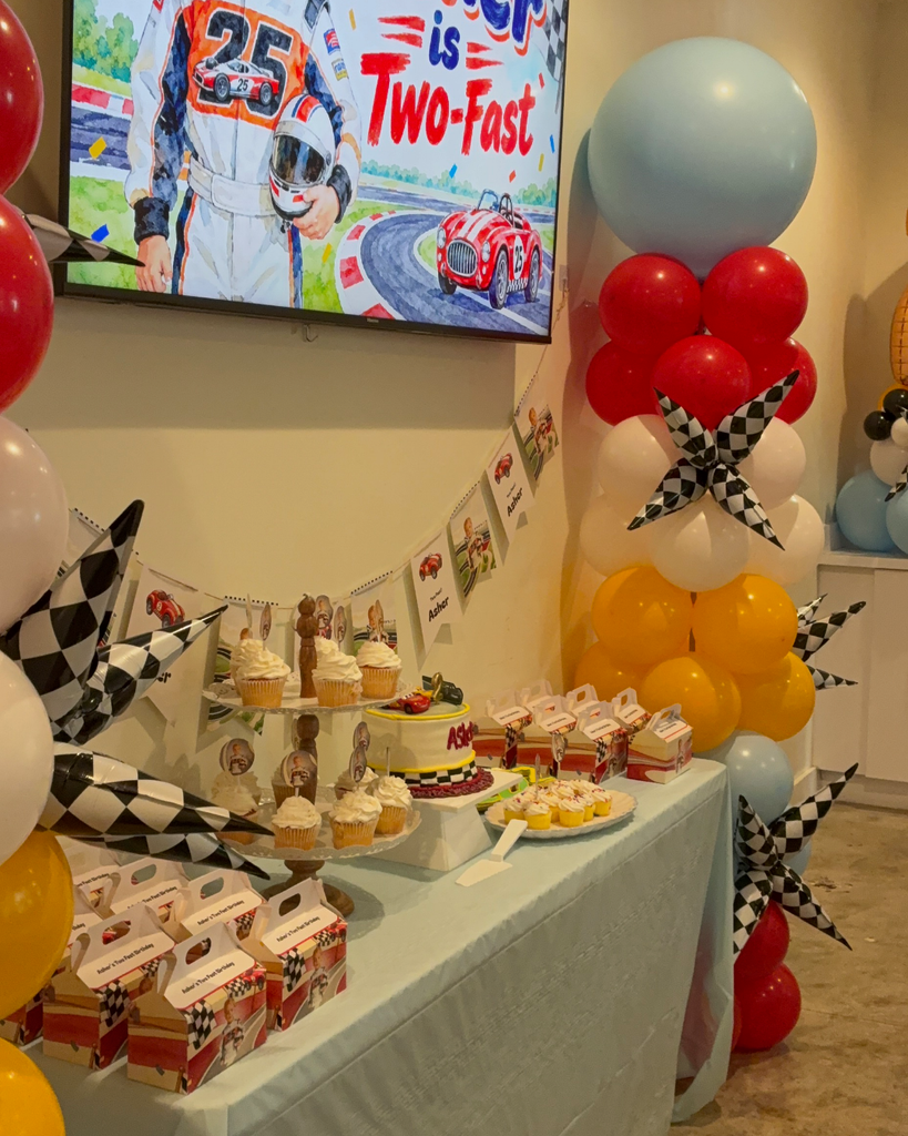 Two Fast race car themed kids birthday party room with balloon columns and set tables in Sandy Springs