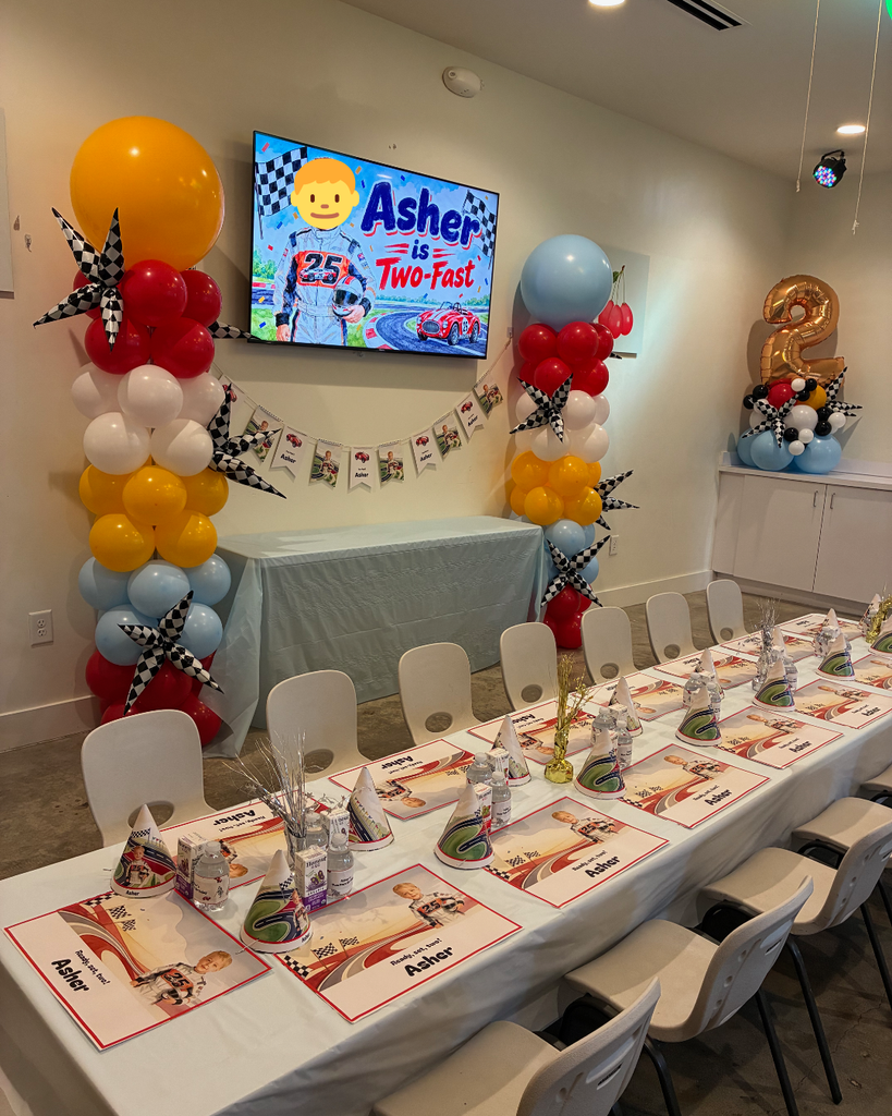 Two Fast race car themed kids birthday party room with balloon columns and set tables in Sandy Springs