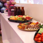 party food, drinks and cupcakes on a buffet for a kid's birthday party.