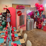 Girl's birthday party decorated with large Barbie balloon display